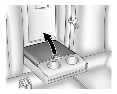 Pull down the armrest. Push the button to lift the cover. Close the cover before folding the armrest up.