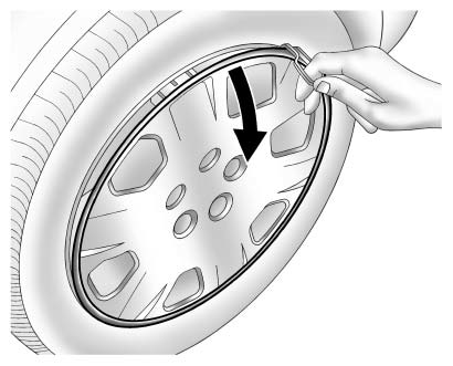Take off the wheel cover or center cap, if the vehicle has one, to reach the wheel bolts.