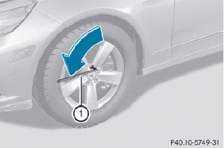 •► Using lug wrench 1, loosen the bolts on